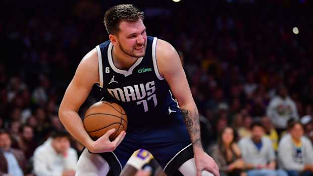 Dallas Mavericks superstar Luka Doncic grimaces after pulling down a rebound during the 2022-23 NBA season.